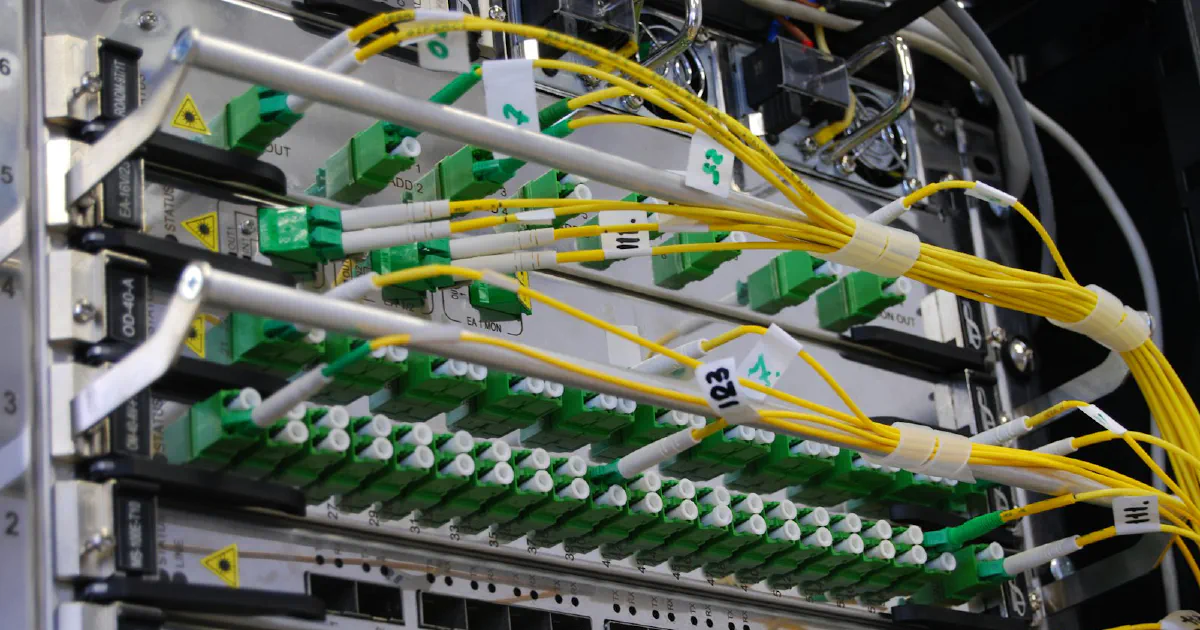 Fiber optic cables connected to a network switch in a server rack