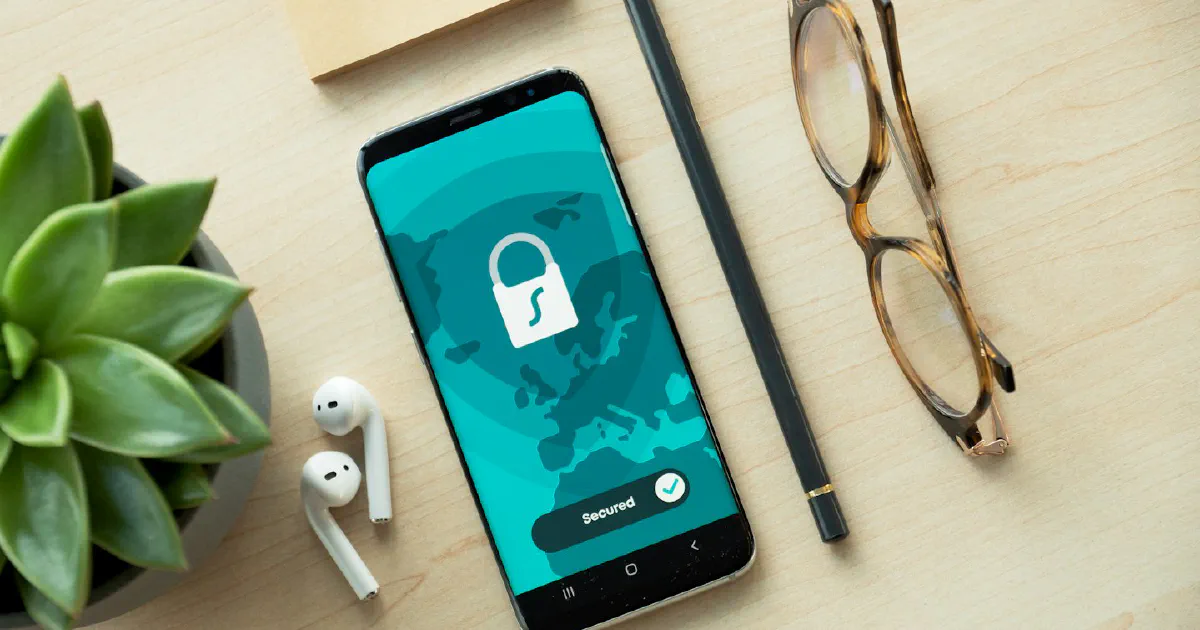 Smartphone showing a security lock icon on a desk