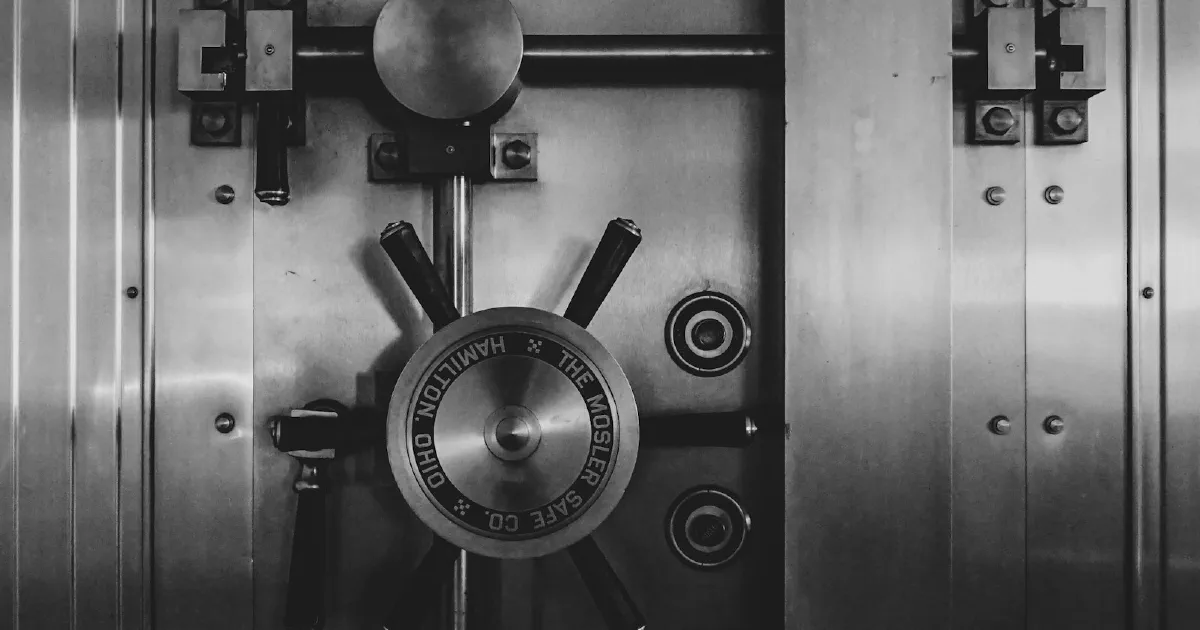 Heavy steel bank vault door with a large circular locking wheel