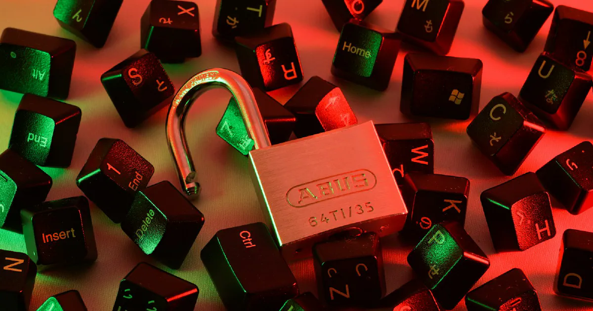 Open padlock surrounded by scattered keyboard keys